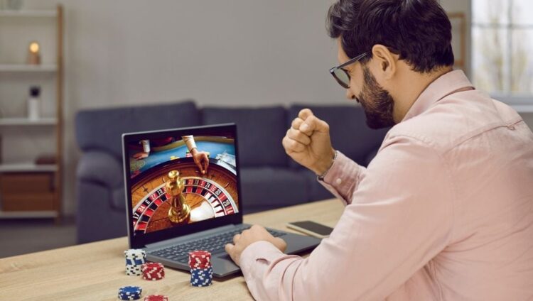 A man playing online casino games at home