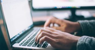 A person typing on a laptop