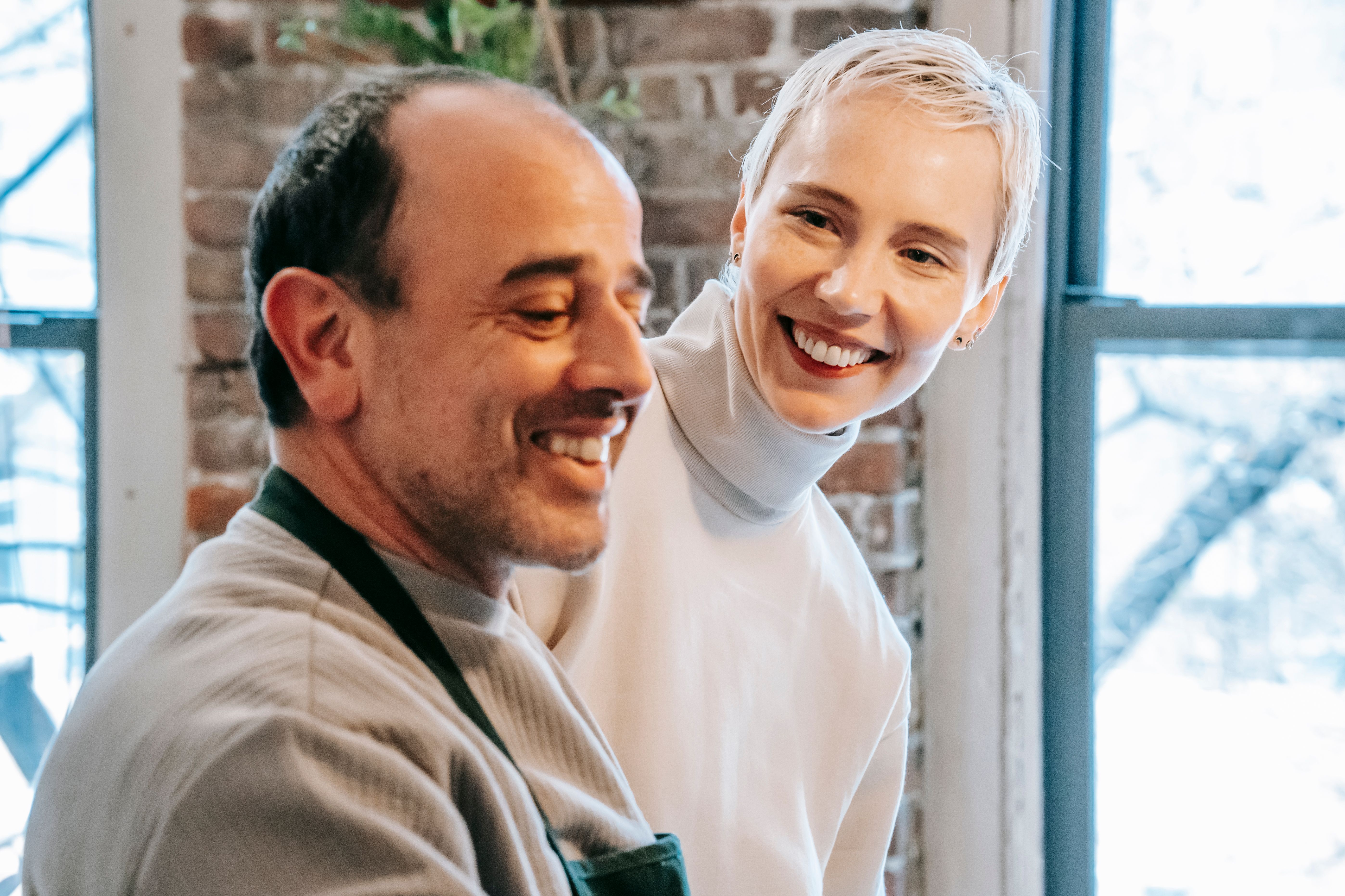 Mature man and woman talking together at home, representing communication in an age-gap relationship.